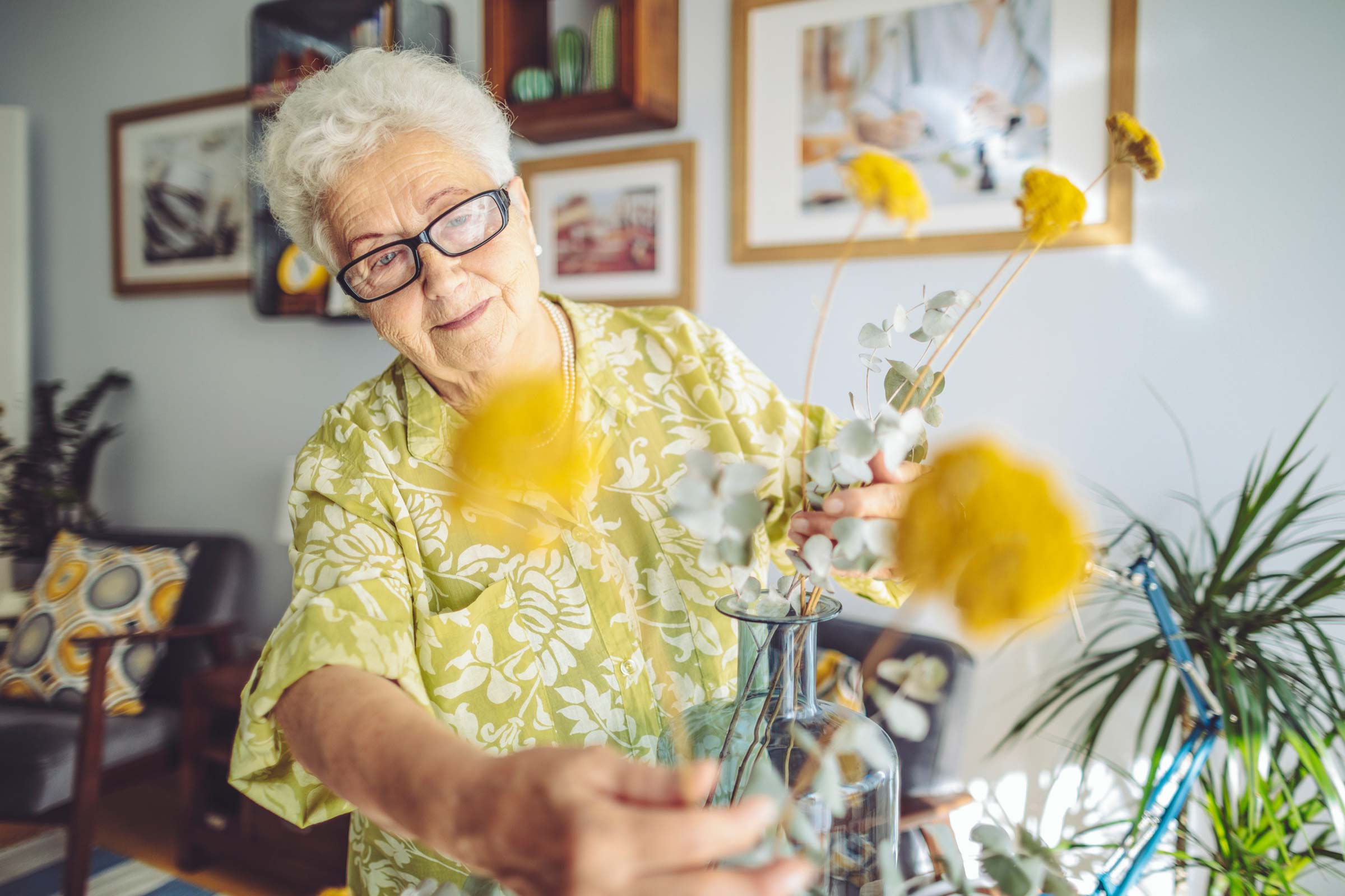 Female personal care resident arranging flowers